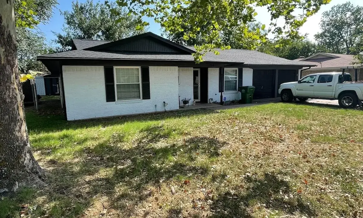 Professional roofing crew working on a residential roof in Hollis